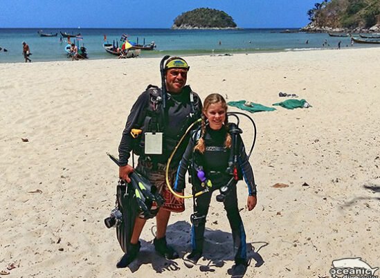 A young diver and her instructor pose at the entry point of Kata Beach North Reef.